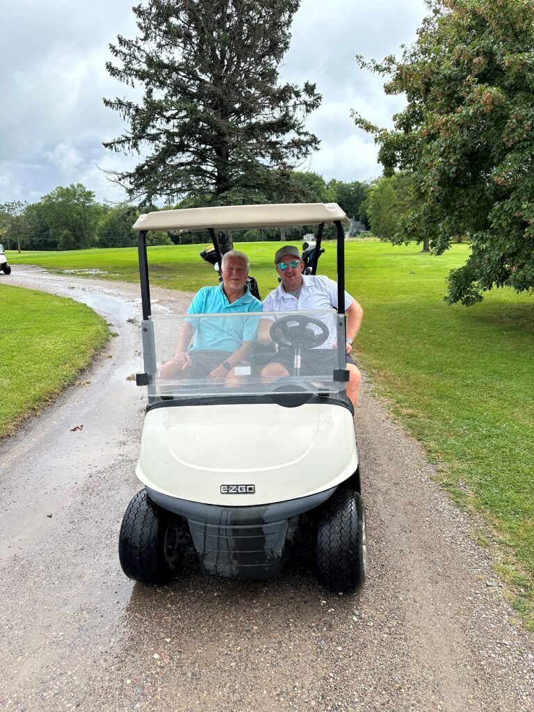 Scott and Danny in golf cart